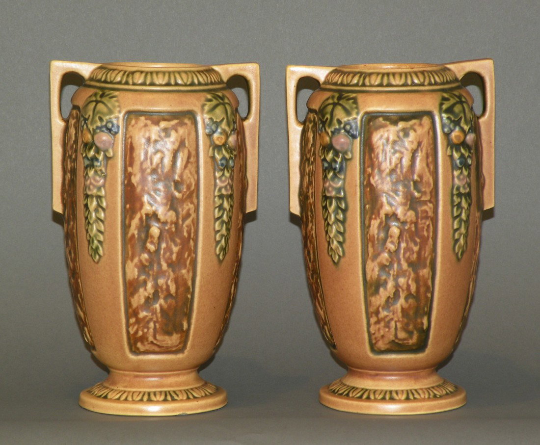 2 brown Roseville "Florentine" vases: ca. 1925; with handles and one retaining a paper label, 4 ¼"d, 8 ¼"h;