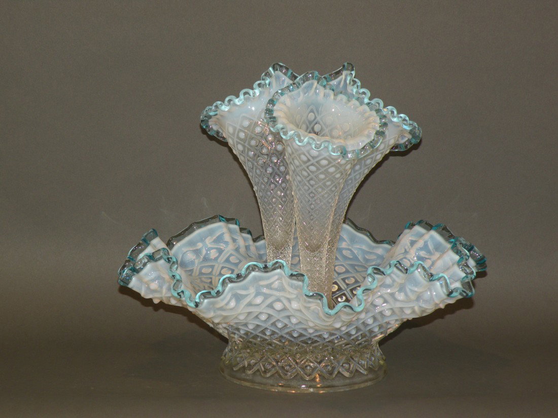 Molded glass epergne: ca. 1900; opalescent hobnail with blue ruffled rims within diamond pattern lattice and three cornucopia set in a bowl, 12 3/8"d, 10 ½"h;