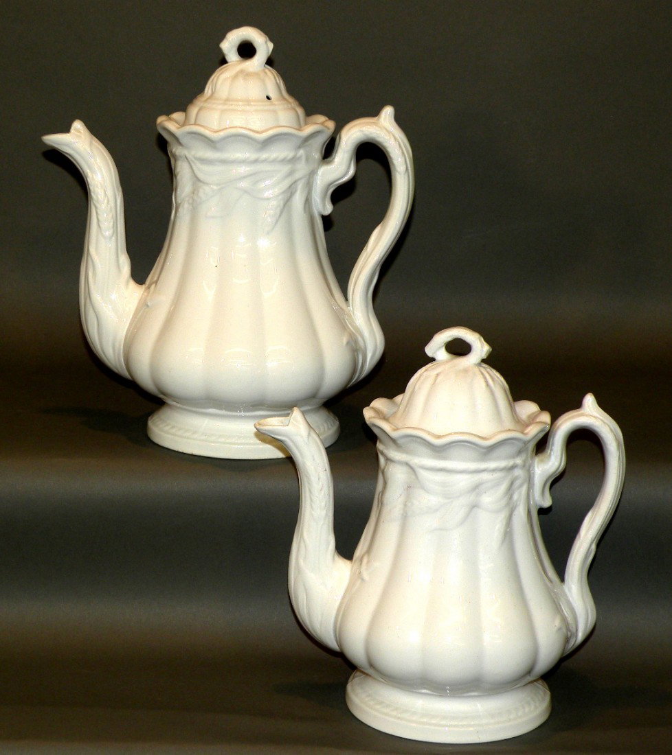 2 white ironstone wheat teapots: ca. 1870; covered small pot marked "Royal Patent Ironstone, Turner, Goddard & Co." 5 7/8"d, 9 ¼"h; larger 6 5/8"d, 10 7/8"h;