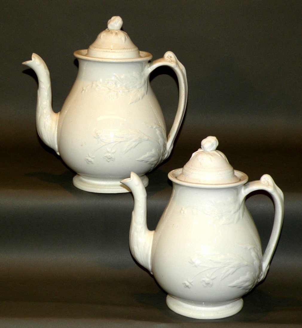 2 white ironstone covered teapots: ca. 1863; floral design with "John Meir and Son - Washington Shape" impressed mark, 6"d, 9 1/8"h; 6 5/8"d, 9 ¾"h;
