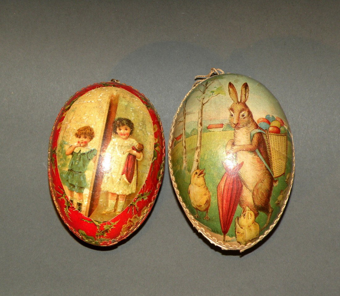 2 German papier mache eggs: ca. 1910-20; rabbit with egg, chicks and rooster, 4"; children playing and holding a doll;