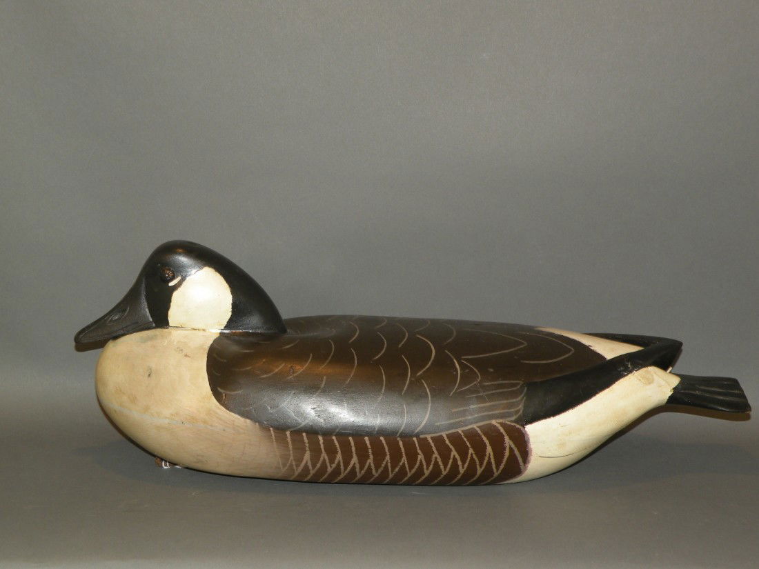 Delaware River Canada goose decoy: ca. 1940-50; low-head hollow goose with upholstery tack eyes, lead pad weight, leather line tie, raised wing tips and detailed bill carving, 22";