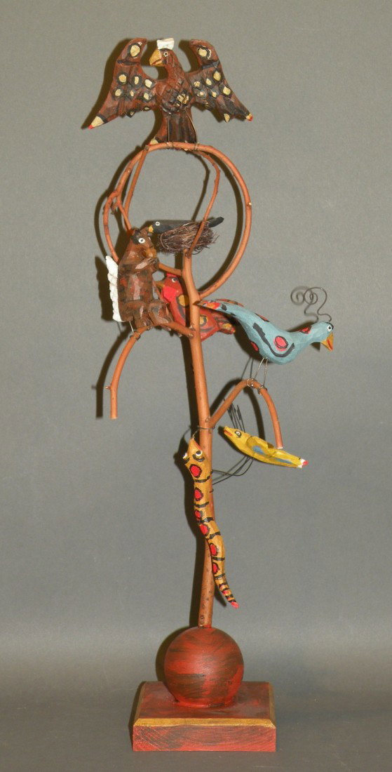 Strawser critter tree: ca. 2005; signed with carved spread wing eagle on top and a squirrel eating a nut, black bird, rooster, peacock, dragonfly and snake, 17";