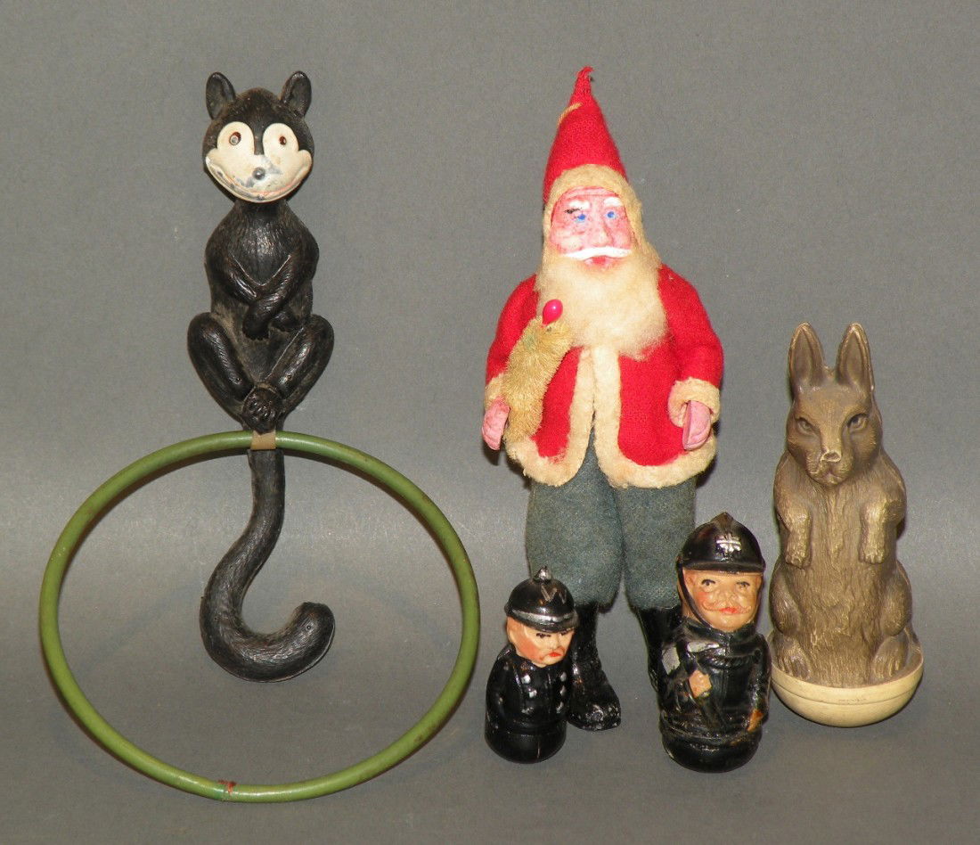 5 small toys: ca. 1930; bendable Santa, 4 ½"; Felix the Cat celluloid rattle; German celluloid roly poly soldier, 1 ¼"; German celluloid roly poly fire fighter 2"; roly poly rabbit;