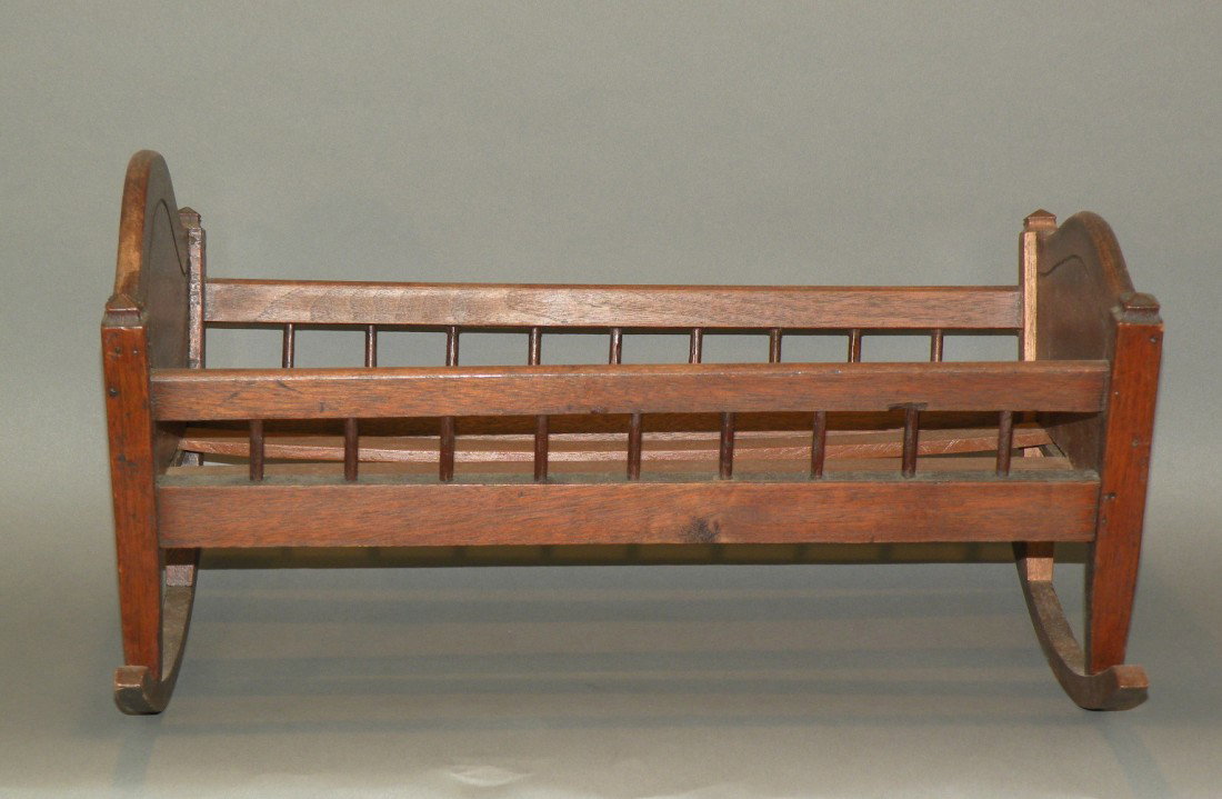Child's doll cradle: ca. 1900; carved walnut, 18";