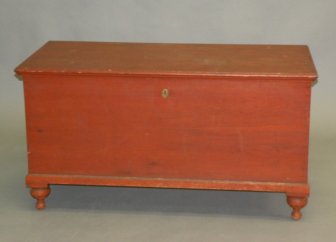 Pine blanket chest: ca. 1830-50; dovetailed chest with original red wash, lock and butt hinges on turned feet, 48 ½"x 21"x 26";