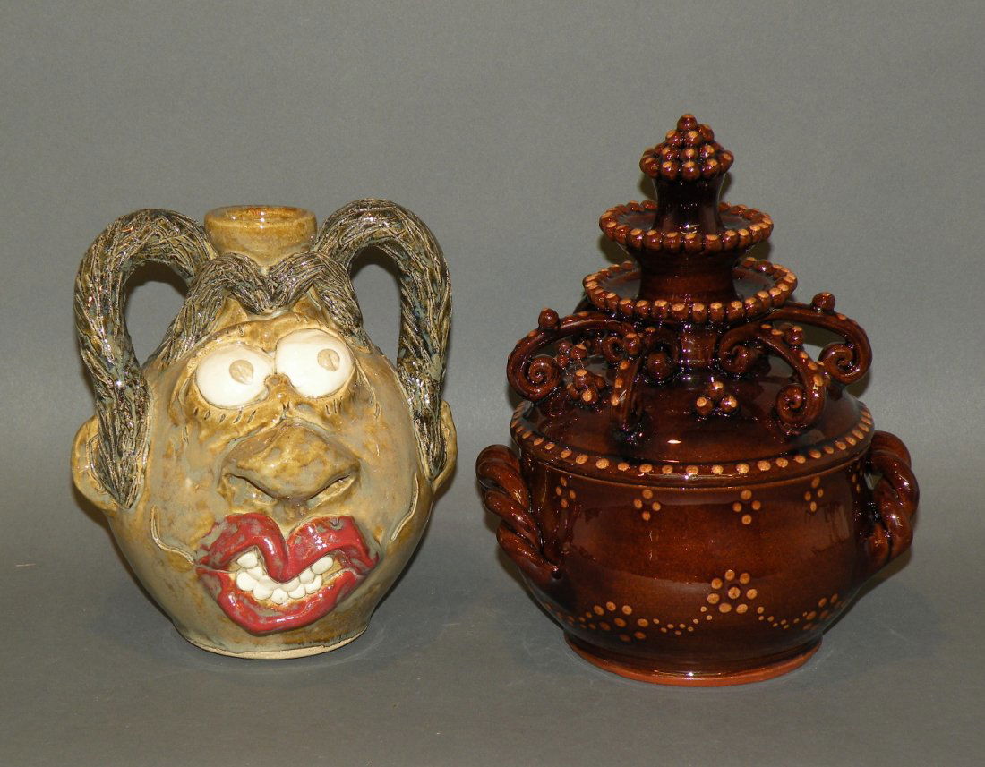 2 pieces of pottery: ca. 2007; earthenware face jug with polychromal glazes in browns, red and white marked “Anna King, King’s Pottery Seagrove NC 2007” on base, 4 7/8”d, 6 5/8”h; covered redware pot by Greg Zie
