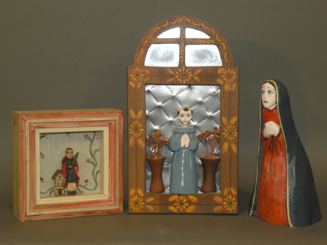 3 wooden carvings: ca. 1980s; Anita Romero Jones signed religious man with punched tin background, mirrors and painted arch; Anita Romero Jones signed “Our Lady of Sorrows” carving; Irene Harting Yates glass enclose