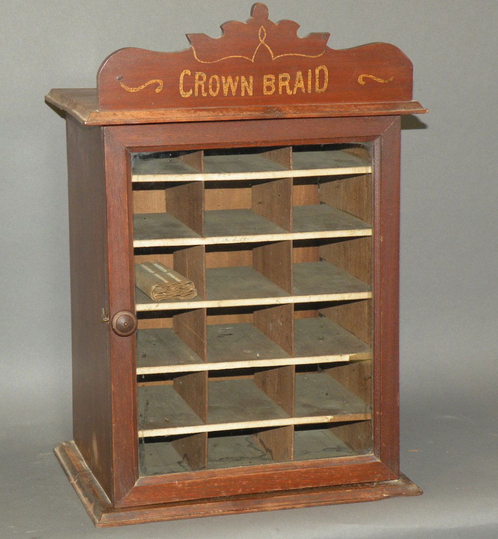 Crown braid thread display & contents: ca. 1900; Crown Braid sign on top of wooden case display with 20 razors and 2 sets of gold frame glasses;