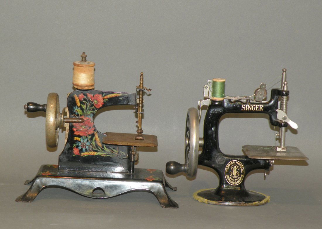 2 child’s sewing machines: ca. 1920-40; tin German sewing machine, 8”x 7 ½”; Singer cast iron machine, 6 ½”x 7”;