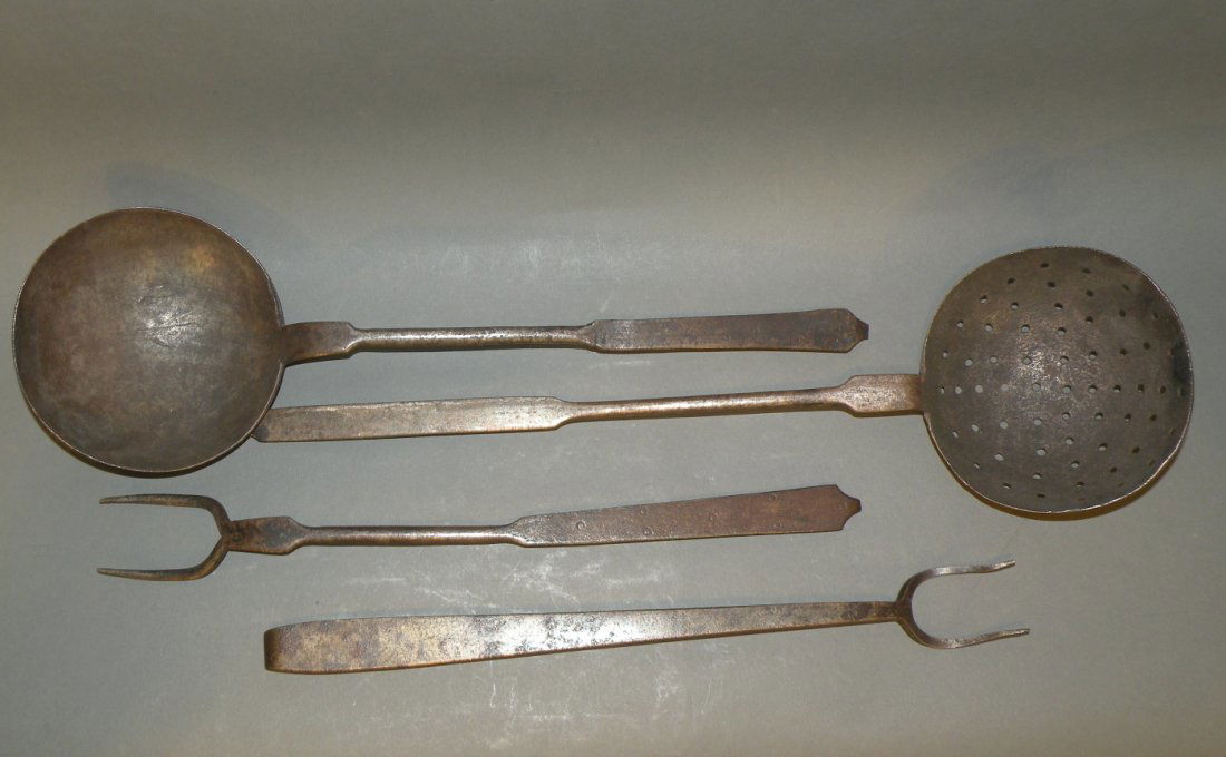 4 wrought iron butcher utensils: ca. 1840-1900; ladle with punched decoration on handle, 17 ¾”x 5 3/8”; matching flesh fork, 15 ½”x 1 ¾”; skimmer, 18 ¾”x 5 ¼”; later flesh fork with broad handle, 15 ¼” 1 5/8”;