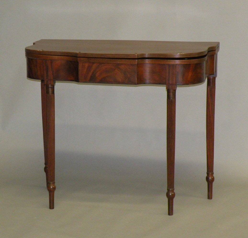 Sheraton card table: ca. 1810; shaped mahogany top with triple reeded sides and tapered reeded legs, 35”x 36”x 29”;