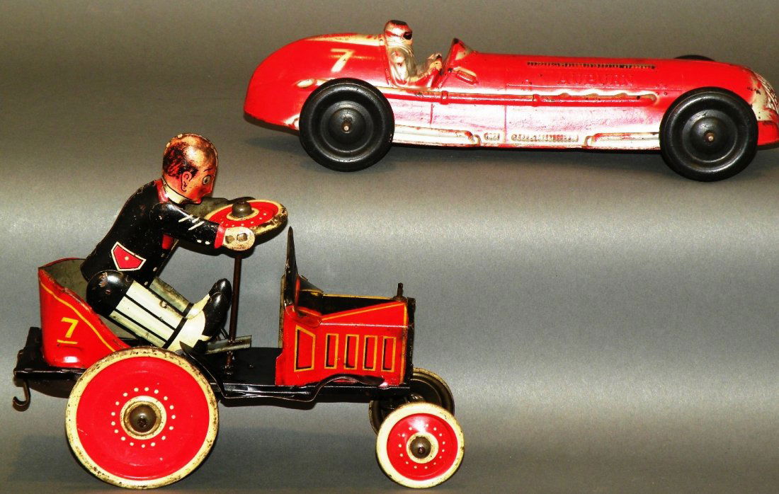 2 race cars: ca. 1930; tin litho Marx wind-up coo-coo car with Jalopy going back and forth and driver going up and down, 8”; large red and silver Auburn rubber race car, 10 ¾”;