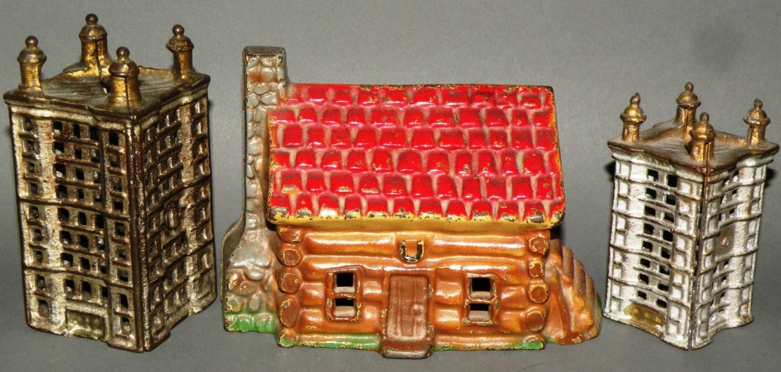 3 cast iron banks: ca. 1900-70; John Wright lucky cabin, 6”; pair of matching AC Williams skyscrapers, 4 ½” & 3 ½”;