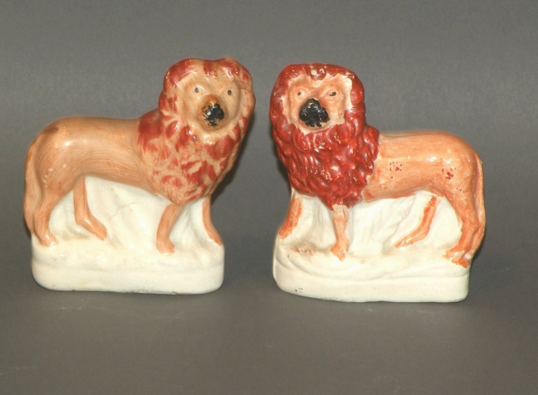 Pair of Staffordshire lions: ca. 1880; earthenware lions decorated in burnt orange, mahogany and black, 3 3/8”x 1 1/8”x 2 7/8”;