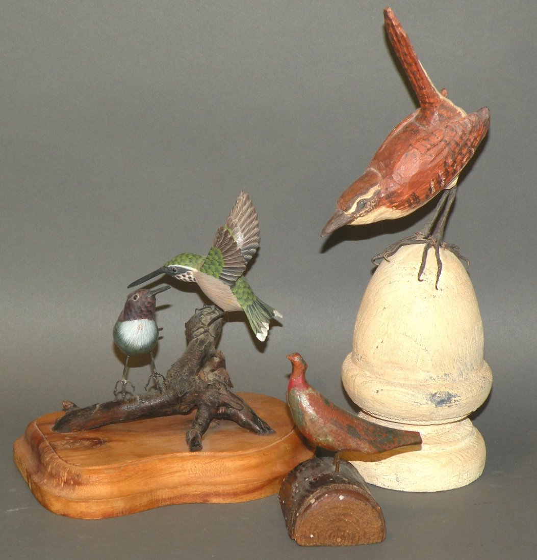 3 bird carvings: ca. 1980s; pair of hummingbirds mounted on a base and signed by George Nelson; miniature pheasant carving; folk art bird carving in primitive style mounted on base with antiqued paint; 3 ½”- 11”;