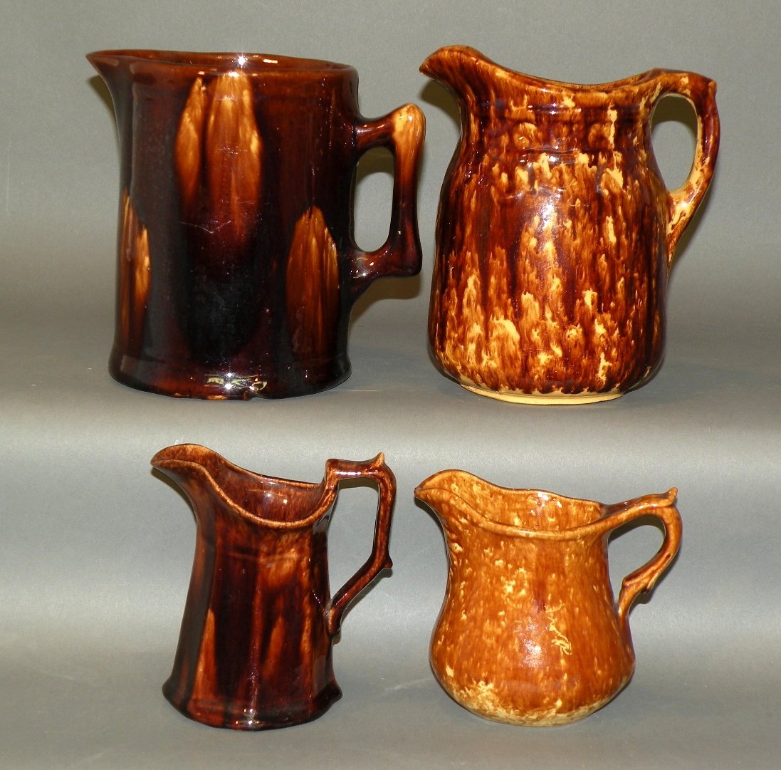 4 pieces of Rockingham glazed earthenware: ca. 1890; molded creamer, 4 ¼”x 3 ¼”x 3 7/8”; eight panel molded creamer, 4 7/8”x 3 1/8”; molded pitcher, 5 1/8”d, 7 ¼”h; molded pitcher, 5 1/8”d, 6 ¾”h;