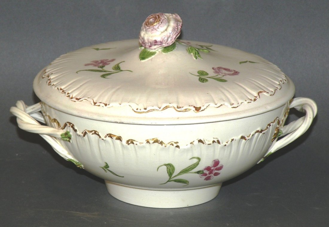 Wedgwood covered bowl: ca. 1780; creamware gilt edged linen fold pattern with lavender and green flower and foliage design with intertwined rope handles, rose blossom finial and impressed “Wedgwood”, 7 3/8”d, 4 ½”h
