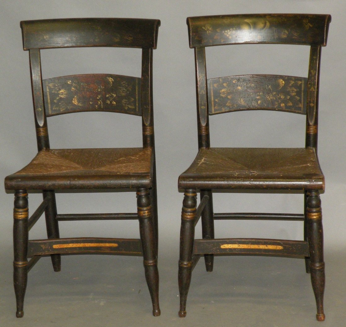 Pair of paint decorated chairs: ca. 1820-50; with rush bottoms, carved backs with scrolled rail, original stencil and freehand decoration on faux mahogany painted ground, 18”x 18”x 33 ½”;
