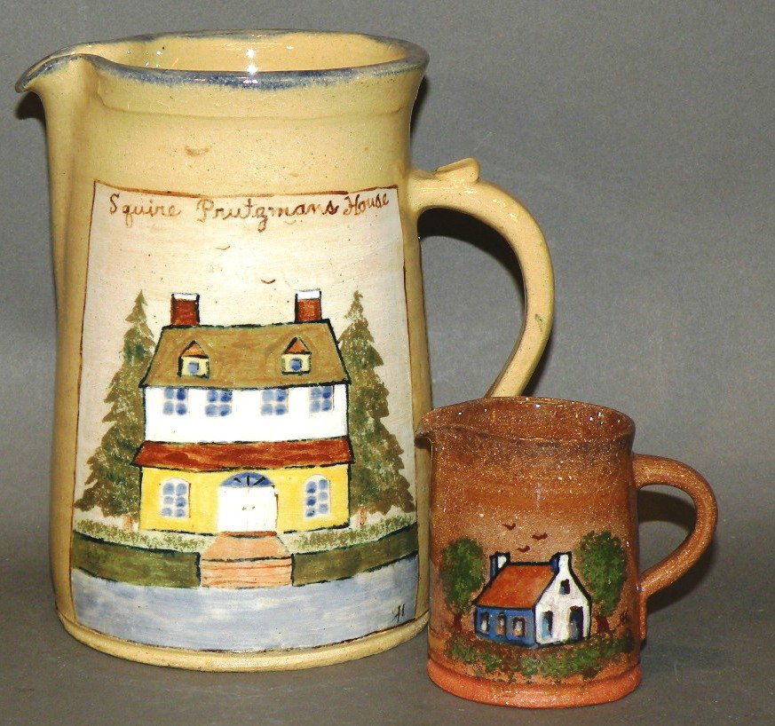 Left handed Russell Henry cream & pitcher: ca. 1972-81; brown glazed redware creamer with polychromal cottage motif and incised “9/72 Left Handed Russell Henry”, 2 1/8”d, 2 5/8”h; maize glazed earthenware pitcher with beige panel of po