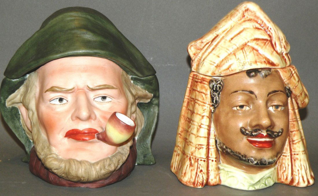 2 figural tobacco jars: ca. 1900; continental earthenware polychromal figures of an Arab, 6 ¼”x 4 ¼”x 4 7/8”; bisque continental polychromal figure of a pipe smoking fisherman, 5 7/8”x 4 ¾”x 5 ¼”;