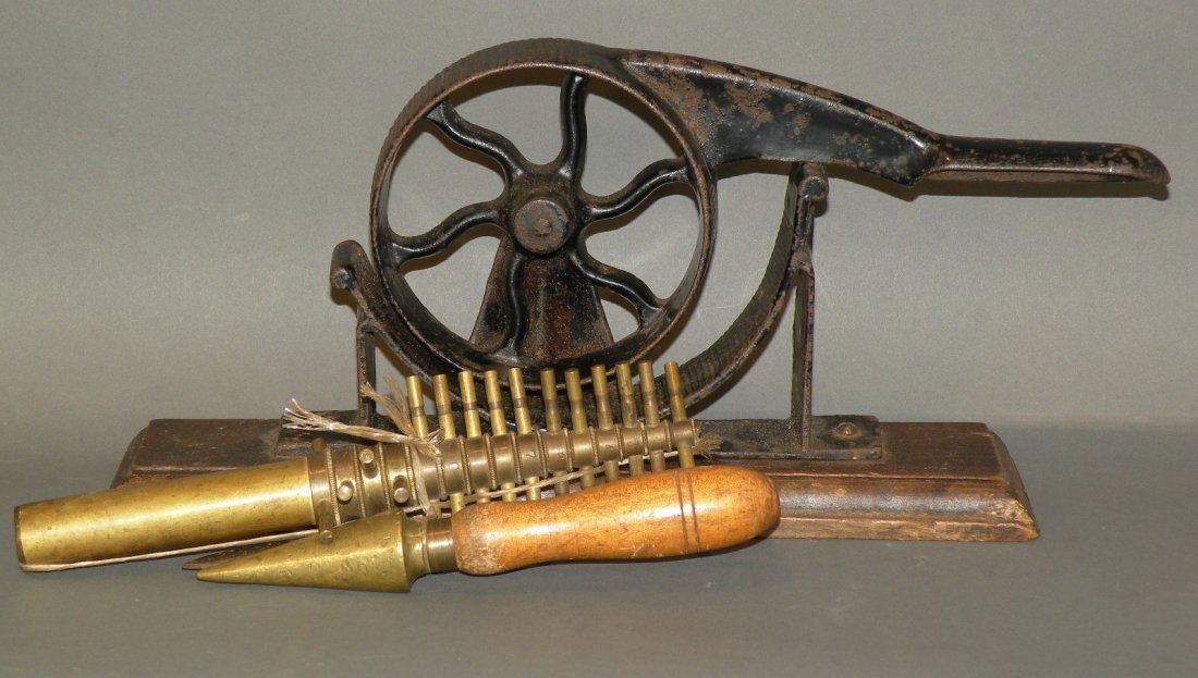 Group of cork related tools: ca. 1890-1920; 15 piece graduated English brass cork cutter; cork trimmer knife; unsigned #2 cast iron wheel shaped cork press on wooden base;