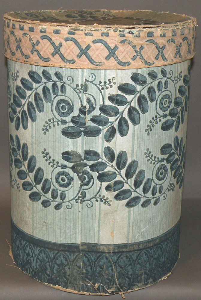 Wallpaper box: ca. 1830-50; cylindrical form box covered in flocked wallpaper having a manufacturer’s label for “Mark Worthley, Band and Fancy Paper Box… Boston” and merchant’s label for Steven W. Olney, B