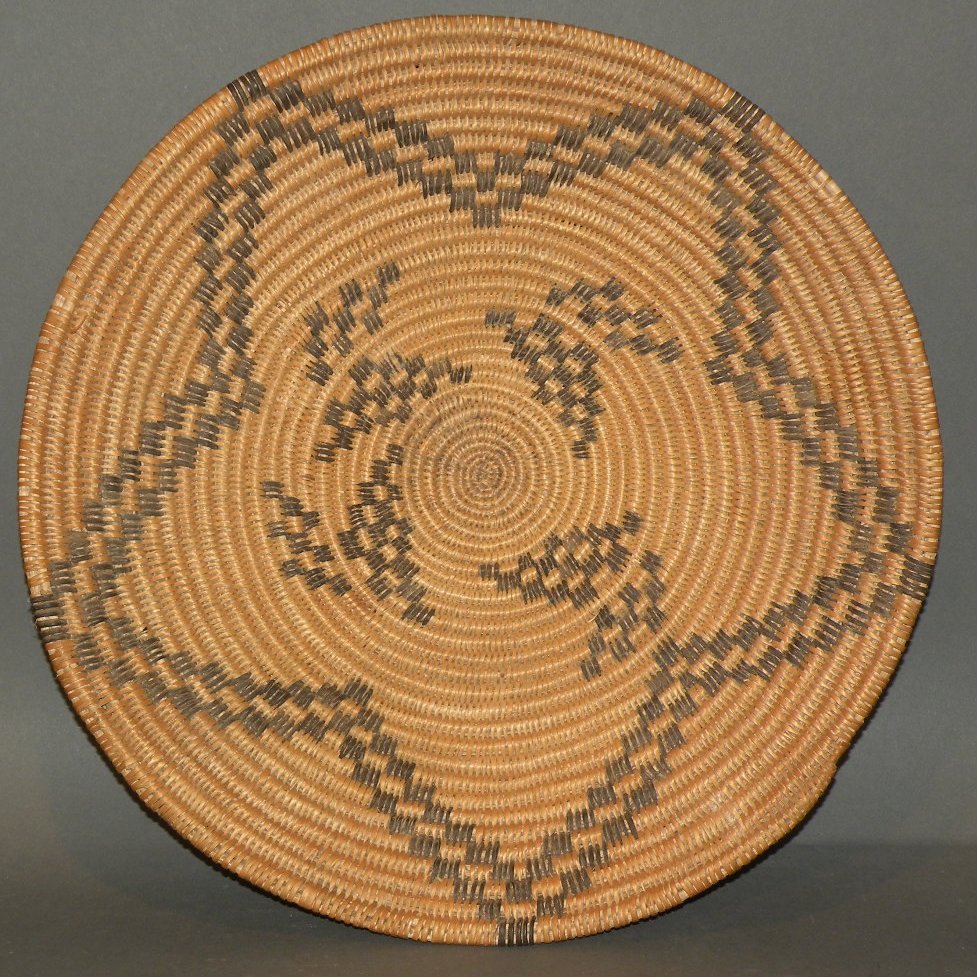 Native American basket: ca. 1920-60; southwestern Apache coil woven with black dyed weavers forming a star design, 12 7/8”x 1 ¾”;