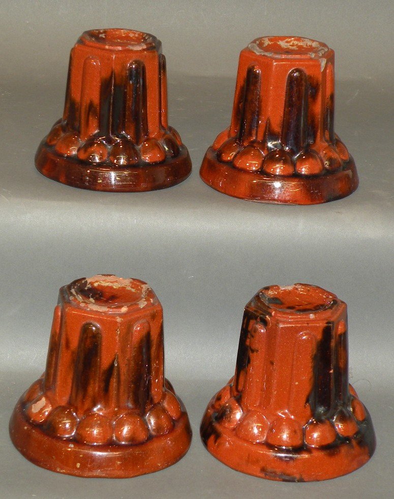Set of 4 redware stove feet: ca. 1880; PA lead glazed with manganese streaking and molded round bases with hexagonal shafts, 4 ½”d, 3 7/8”h;