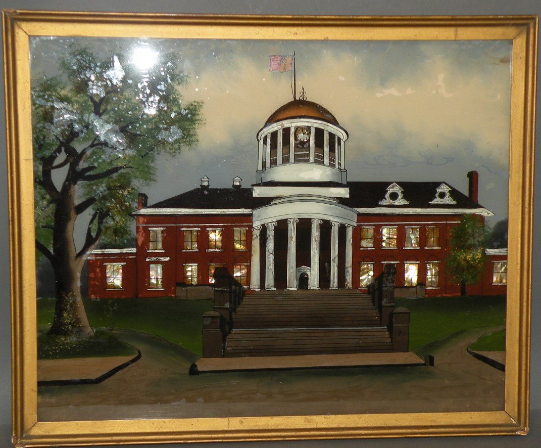 Reverse painting on glass: ca. 1920; rendering of a state house with clock tower and American flag with use of mother of pearl in a gold colored frame, 22”x 18”;