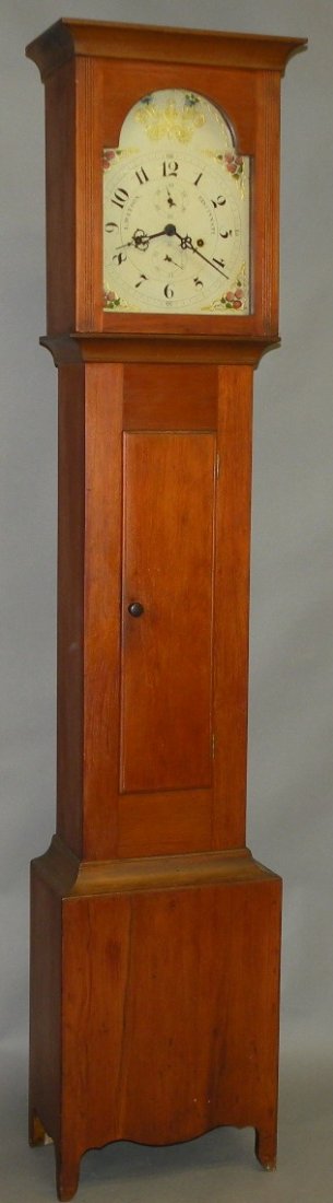 Luman Watson tall case clock: ca. 1820; case of pine with a flat top bonnet fluted front flanking dial opening above the rectilinear trunk and door over the base with shaped skirt and French style feet with a wooden 30 hour time a
