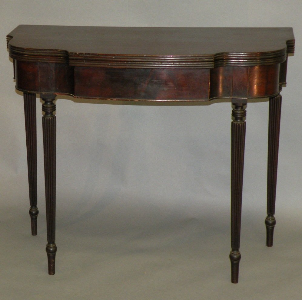 Sheraton style mahogany card table: ca. 1920; typical Philadelphia form with “D” shaped top, turned and reeded legs and flip top with reeded edges, 29”x 36”x 17 ½” closed;