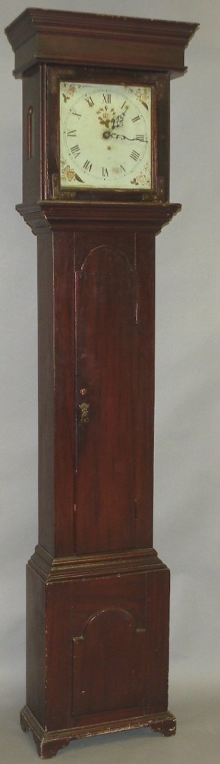 Walnut tall case clock: ca. 1770; square dial opening in a flat top bonnet with tombstone side lights, tombstone shaped door over base with conforming tombstone raised panel resting on ogee feet, the chain pull one-day time 