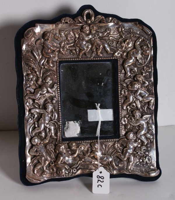 English sterling silver repousse mirror, hallmarke: English sterling silver repousse mirror, hallmarked: W H (William Hunter), London, date letter 'b' (1897) and King George IV. 12" x 9 1/4"