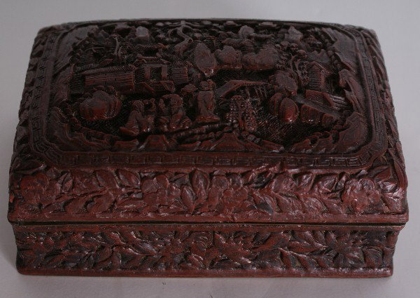 Chinese carved cinnabar lacquer box, signed: Chinese carved cinnabar lacquer box, signed with six character mark. H: 2 1/4" W: 5 3/4" D: 3 7/8"