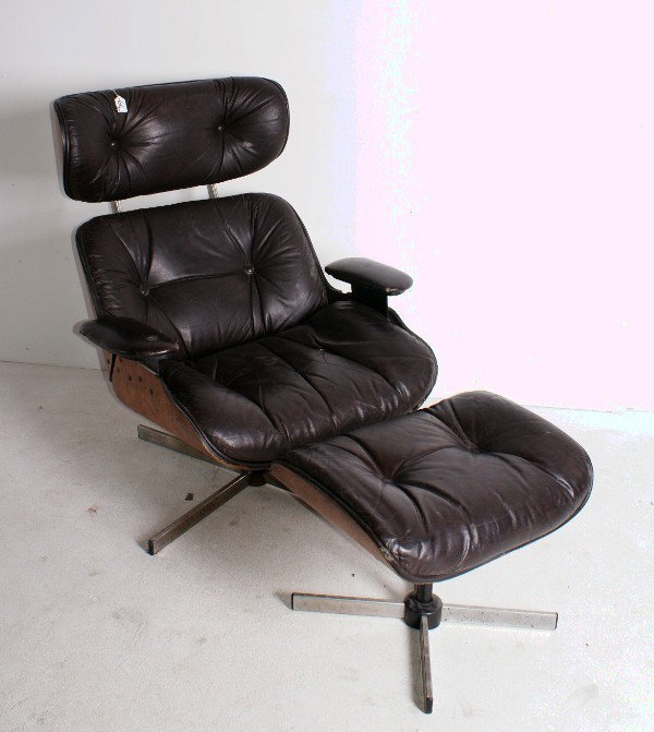 Eames style lounge chair and ottoman, originally de: Eames style lounge chair and ottoman, originally designed for the Herman Miller Furniture Company, released in 1956, molded plywood and leather on metal bases, circa last quarter 20th century.