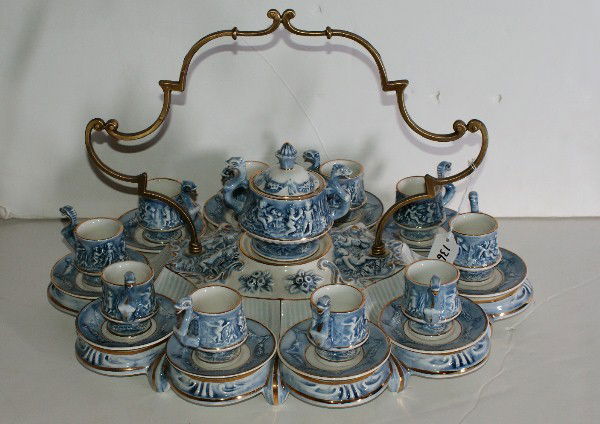 Capodimonte demitasse service; comprised of 10 cup: Capodimonte demitasse service; comprised of 10 cups and saucers, covered sugar and a bronze handle serving tray. H: 13" W: 20" D: 15"