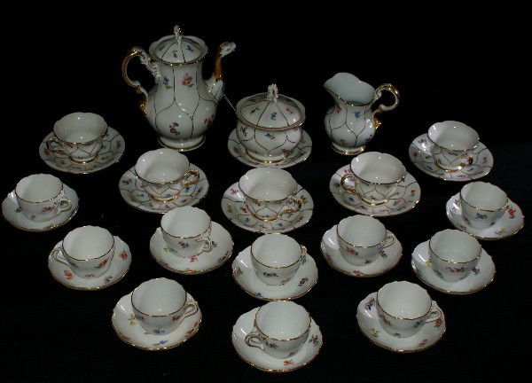 Meissen porcelain thirty-four piece chocolate se: Meissen porcelain thirty-four piece chocolate set, comprising: chocolate pot, sugar, creamer, 10 small cups and saucers, 5 large cups and 6 large saucers, Meissen cross sword mark. Chocolate pot: 8"