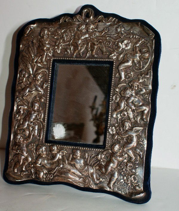 English sterling silver repousse mirror, hallmarked: English sterling silver repousse mirror, hallmarked: W H (William Hunter), London, date letter 'b' (1897) and King George IV. 12" x 9 1/4"