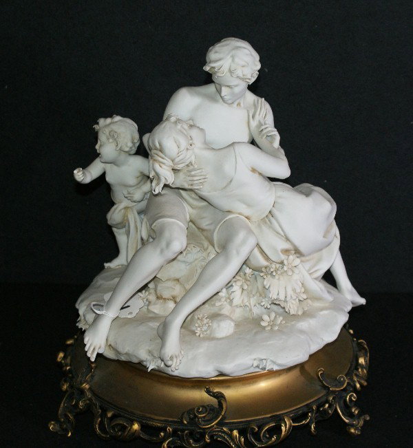 English Parian figural group, 19th century, depi: English Parian figural group, 19th century, depicting cupid and an amorous couple on a bronze base. H: 12" Diameter: 11 1/4"
