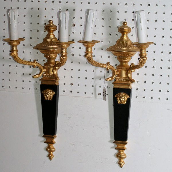 Fine pair of Versace Empire style gilt and patinated: bronze two-light wall sconces; each with leaf and snake-form branches surmounted with urns, Versace masks, verso with Gianni Versace plaque. H: 19"