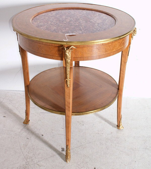 French 19th century Empire style marble-top br: French 19th century Empire style marble-top bronze-mounted satinwood occasional table. H: 29 3/4" Diameter: 28"
