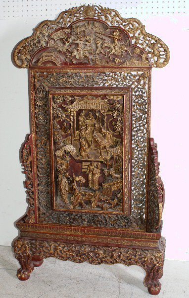 Fine Chinese 19th century carved and lacquered: table screen, elaborately carved with dragon crest over a scenic frieze above a relief carved panel with signature plaque surrounded by a leaf and nut border with squirrels and bat corners on a dragon