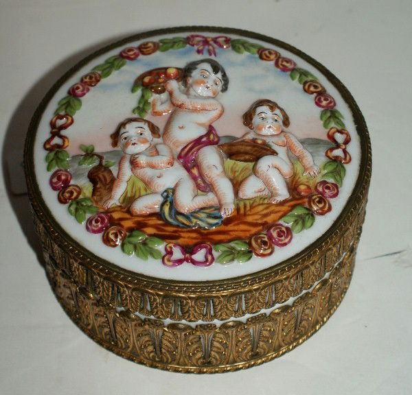 Antique Capodimonte porcelain covered box: Antique Capodimonte porcelain covered box the cover with relief bacchanal figures. H: 2 3/4" Diameter: 6"