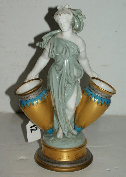 English porcelain figural vase, probably Minton, 19: English porcelain figural vase, probably Minton, 19th century, in the form of a draped classical female figure supporting two amphora vases on a circular base. H: 11"