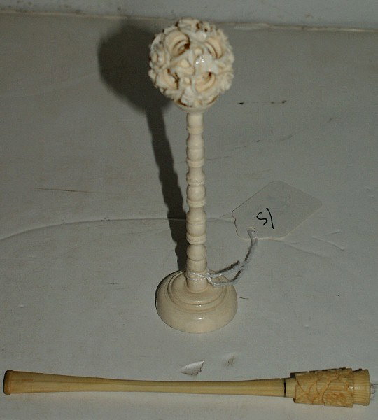 Two pieces of Chinese carved ivory; puzzle ball on: Two pieces of Chinese carved ivory; puzzle ball on stand and a cigarette holder. Each: 5 1/2"