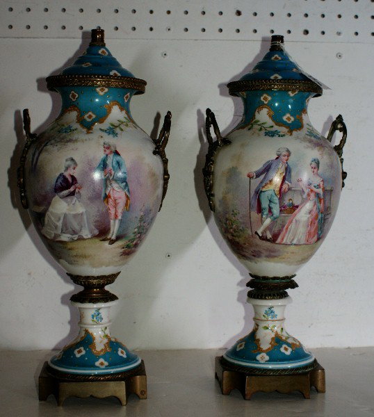 Pair of 19th century Sevres porcelain and bronze-mou: Pair of 19th century Sevres porcelain and bronze-mounted urns and covers with signed (Quentin & Laurent) scenic painted reserves. H: 18 1/2"