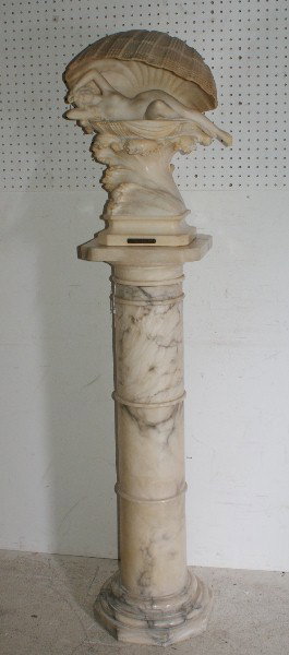 Umberto Stiaccini, Italian 19/20th C,: Recumbent Nude in a Clamshell, alabaster, signed: U. Stiaccini; together with a marble pedestal. Sculpture: 22" Pedestal: 44"