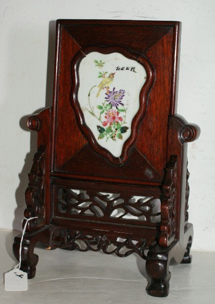 Chinese hardwood table screen: with a shaped porcelain plaque depicting a bird and foliage, signed. H: 13 1/8" W: 9" D: 7"