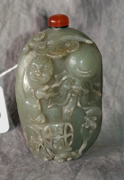 Chinese carved celadon jade snuff bottle with carn: Chinese carved celadon jade snuff bottle with carnelian stopper and ivory spoon. 4 1/4"